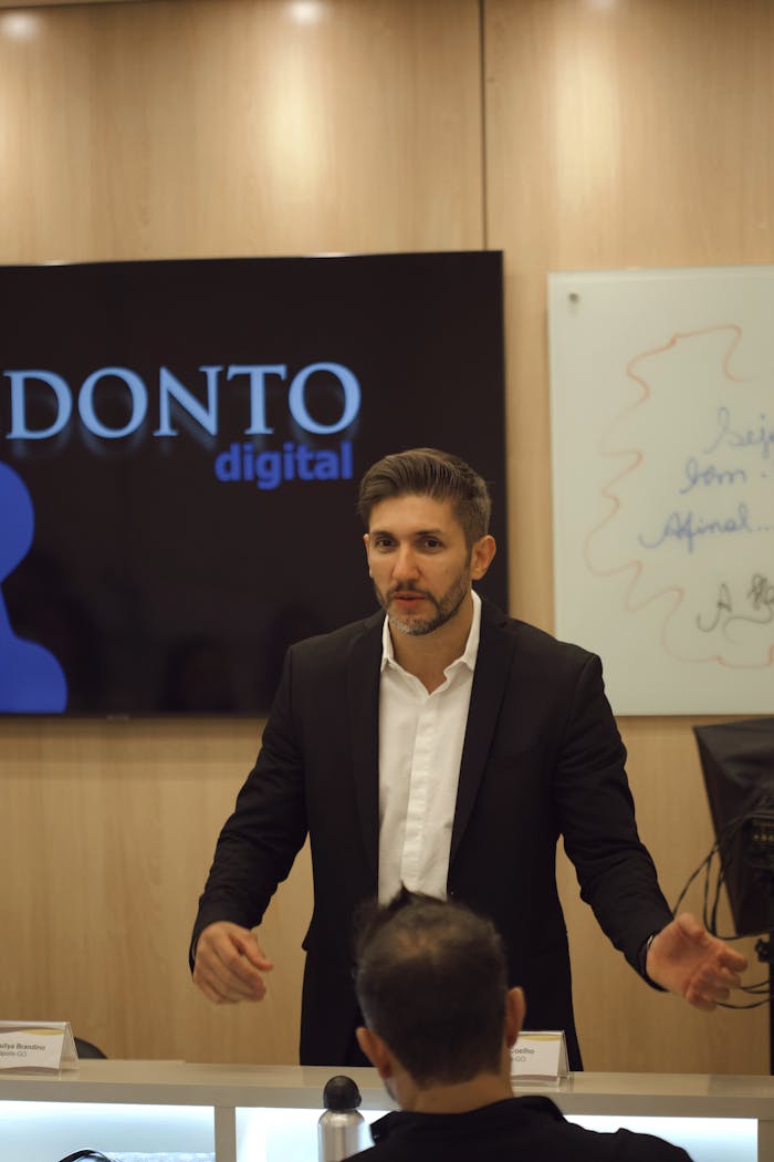Man giving a professional business presentation at a seminar, engaging the audience.